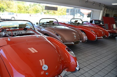 a row of classic sports cars in a showroom
