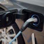 electric vehicle charging cable plugged into car
